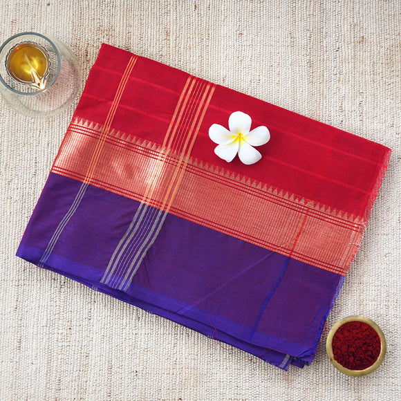 Handwoven deep red consecrated cotton saree with a vibrant royal blue border