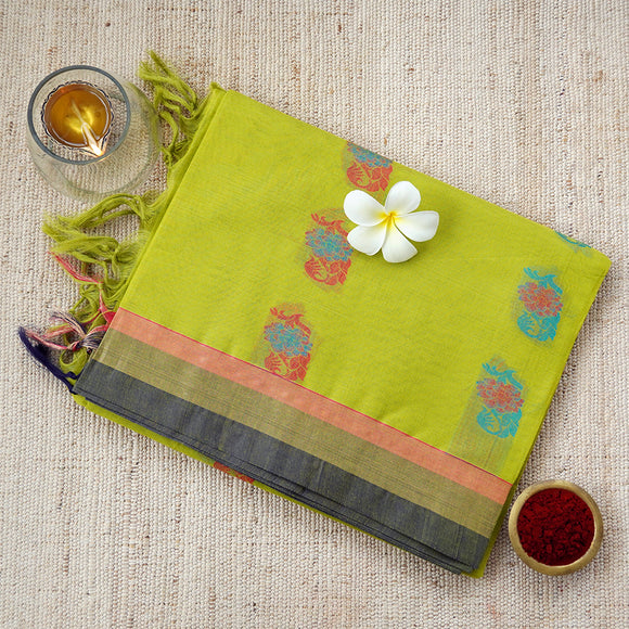 Handwoven olive yellow consecrated cotton saree with beautiful floral art in sky blue and deep pink across the body