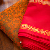 Devi Energised Cotton Saree – Golden Orange with Olive Green Floral Motifs & Vibrant Red Traditional Border