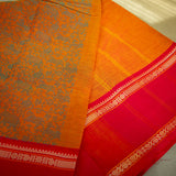 Devi Energised Cotton Saree – Golden Orange with Olive Green Floral Motifs & Vibrant Red Traditional Border