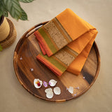 Devi Energised Cotton Saree – Golden Orange with Olive Green & Rust Red Traditional Floral Border