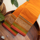 Devi Energised Cotton Saree – Golden Orange with Olive Green & Rust Red Traditional Floral Border