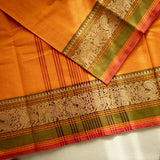 Devi Energised Cotton Saree – Golden Orange with Olive Green & Rust Red Traditional Floral Border